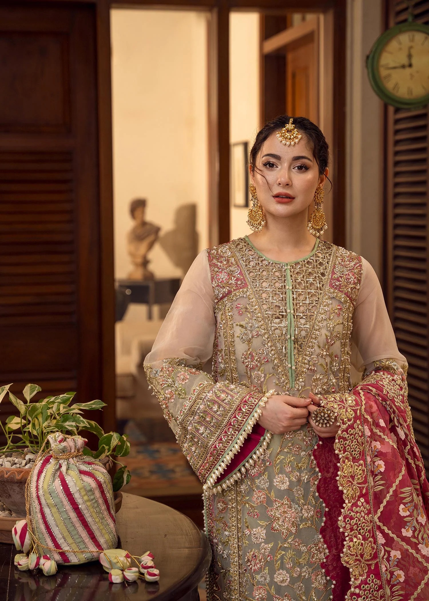 Artisanal Anecdotes Pakistani fashion outfit in gold, pink tones.